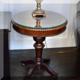 F06. Lane Furniture round wooden cherry side table with a glass protective top. 24”h x 22”w 